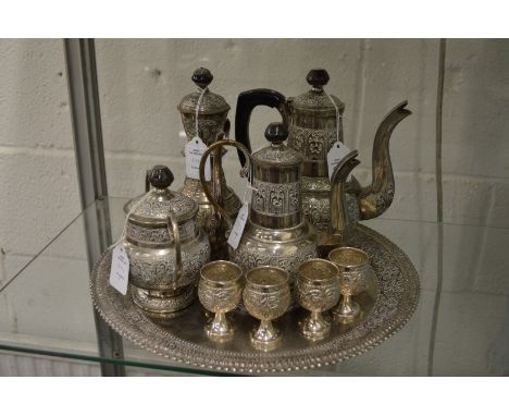 An Eastern white metal four piece coffee service with matching tray and four goblets.