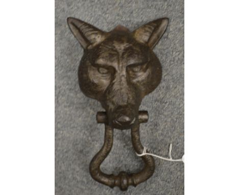 A cast iron fox head door knocker.