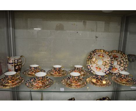 A Royal Crown Derby imari pattern eight place tea service comprising: a pair of cake plates, eight tea plates, cups saucers t