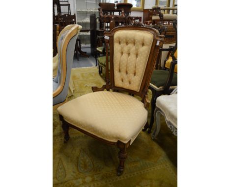 A Victorian walnut button upholstered bedroom chair.