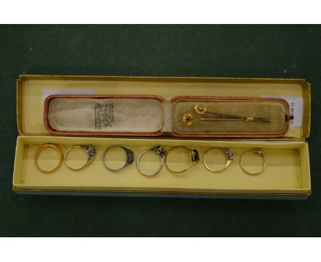 A collection of seven gold and other gem set rings and two tie pins.