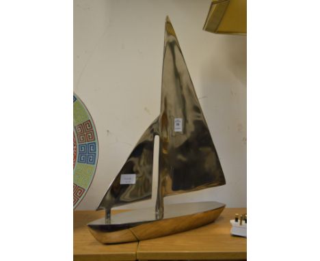 An aluminium model of a sailing boat.