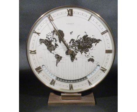 A 1960'S KIENZLE BRASS ELECTRO MECHANICLE WORLD TIME CLOCK. THE 25 cm DIAL SHOWS A MAP OF THE WORLD WITH LOCAL TIME DISPLAYED