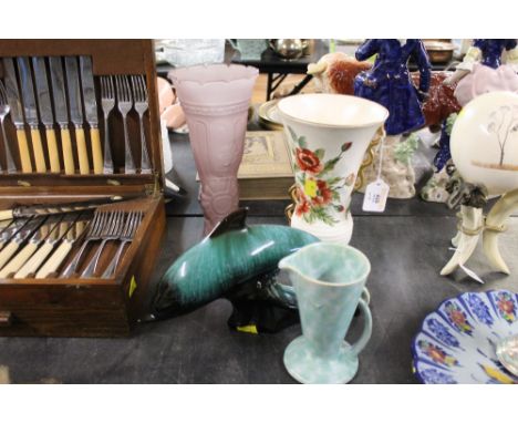 A Vulcan ware floral vase, a glass floral vase, a Poole style dolphin ornament and a Wadeheath ware jug 