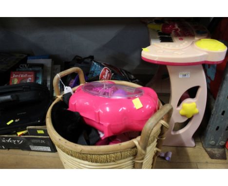 Basket of children's toys, a plastic child's keyboard and roller blades 