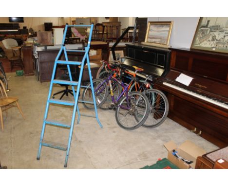 A pair of vintage blue painted metal step ladders 