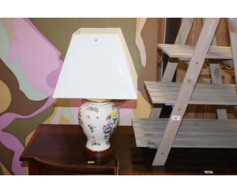 A modern electric table lamp, formed as a floral painted urn with cream tapering shade 