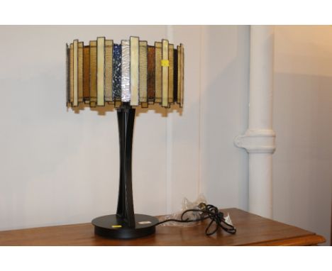 A modern Art Deco design table lamp with leaded glass style shade on black painted metal base 
