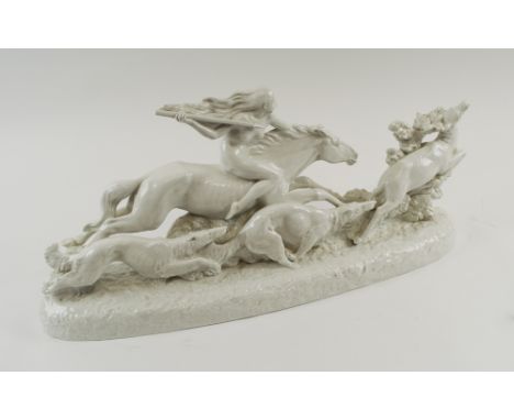 DIANA HUNTING SCULPTURE, white glazed ceramic depicting her on horseback with Borzoi dogs alongside, 60cm L x 28cm H maximum.
