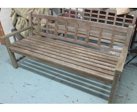 GARDEN BENCH, weathered teak slatted on square supports, 183cm L. 