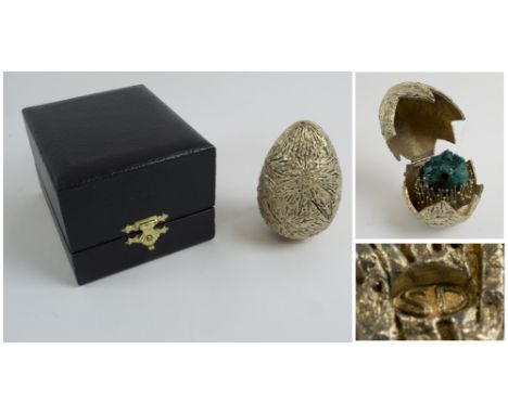 STUART DEVLIN EGG, silver gilt 'cracked' to reveal a green quartz stone nestling inside, London 1971, 7cm H. 