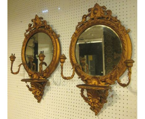 GIRANDOLES, a pair, late 19th century giltwood and gesso with a circular plate, candle sconces and a shelf bracket, 37.5cm W 