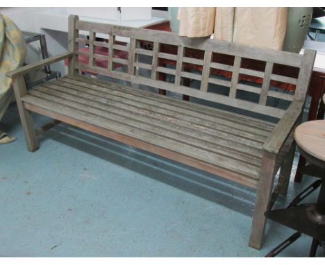 GARDEN BENCH, weathered teak slatted on square supports, 183cm L. 
