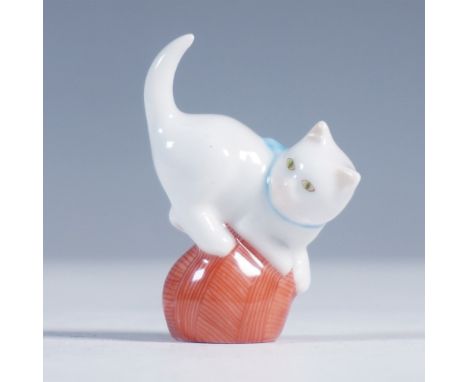 Charming Herend Hungary porcelain figurine of a white cat playfully perched atop a red ball of yarn. Finished in high gloss w