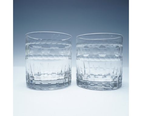 A pair of elegant cut glass double old-fashioned tumblers featuring a distinctive design with a faceted lower section and a r