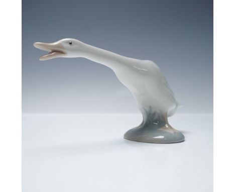 Endearing and full of charm, this Lladro porcelain figurine titled Little Duck (No. 1004551) features a wide-mouthed duck cap