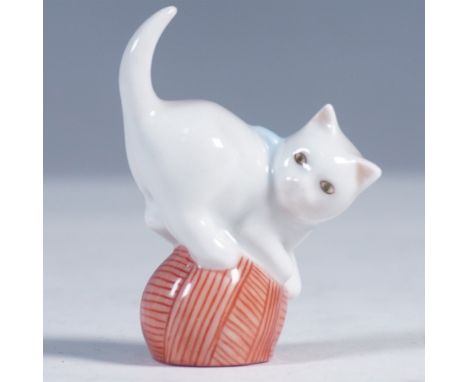 Charming Herend Hungary porcelain figurine of a white cat playfully perched atop a red ball of yarn. Finished in high gloss w