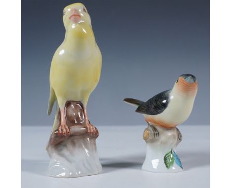 Pair of handpainted Herend porcelain bird figurines made in Hungary. The taller figurine features a yellow songbird perched o