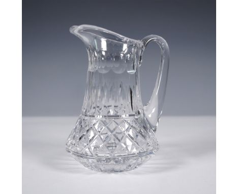 Brilliant cut crystal water pitcher featuring a classic flared form with an elegantly arched handle. The body is adorned with