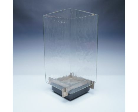 Elegant and modern, this Hurricane lantern features a striking combination of textured glass set into a marble and metal base