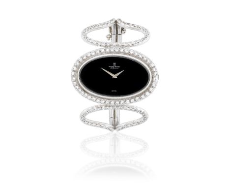 Montre Royale. An 18K white gold and diamond set manual wind oval bracelet bangle watchReference: 5703Date: London Hallmark f