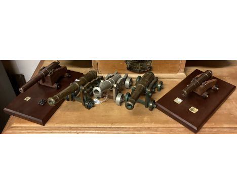 Three brass mounted cannons together with two other model cannons. Est. £20 - £30.
