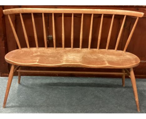ERCOL: A two seater stick back bench. Est,. £50 - £80.