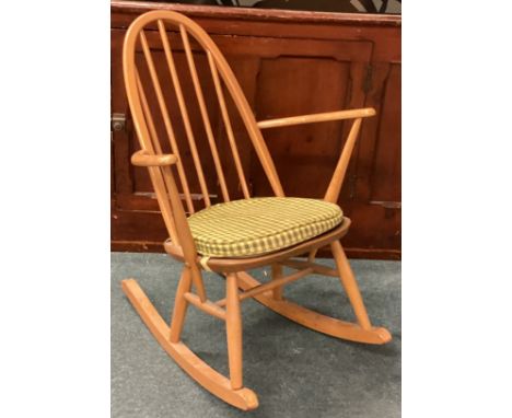 ERCOL: A small rocking chair. Est. £40 - £60.