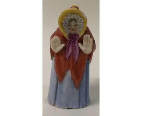 A 19th Century Royal Worcester porcelain candle snuffer; Madam Snow in blue spotty dress. Est. £10 - £20.