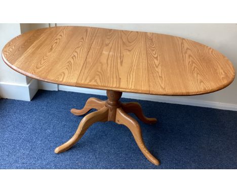 ERCOL: A good draw leaf table of typical form. Est. £100 - £150.