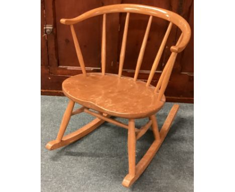 ERCOL: A small rocking chair. Est. £40 - £60.