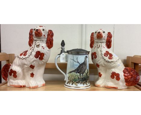 A pair of Staffordshire dogs together with a pottery stein. Est. £20 - £30.