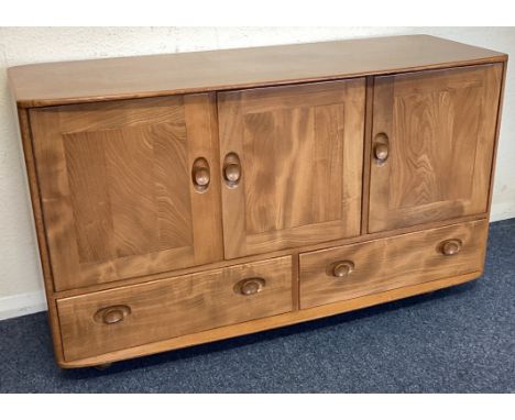 ERCOL: A three-door sideboard. Est. £50 - £80.