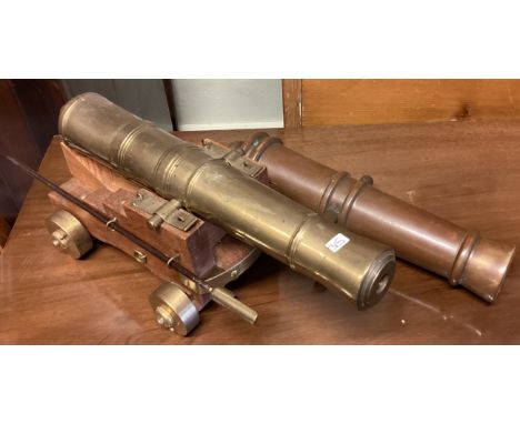 A large oak and brass model of a cannon etc. Est. £20 - £30.