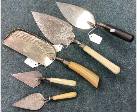 A large silver mounted and ebony trowel together with four plated examples. Est. £20 - £30.