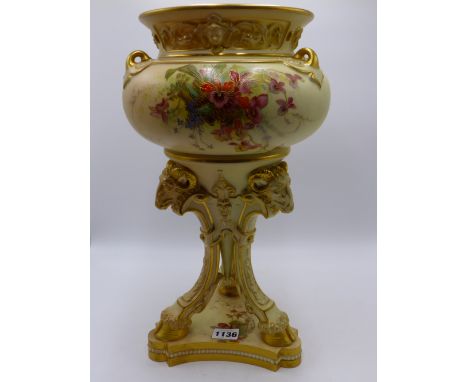 A ROYAL WORCESTER LARGE CENTREPIECE IN THE NEO CLASSICAL TASTE. TRIFORM BASE WITH RAM'S HEAD SUPPORTS, POLYCHROME FLORAL SPRA