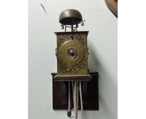 A JAPANESE KAKE-DOKEI LANTERN CLOCK WITH FOLIOT REGULATION AND BELL ALARM, UNSIGNED ENGRAVED DIAL AND BRASS CASE, MOUNTED ON 