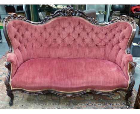A GOOD VICTORIAN CARVED ROSEWOOD SHOW FRAME BUTTON UPHOLSTERED SALON SETTEE.   
