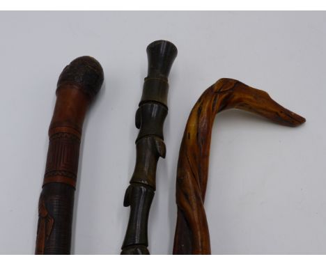 A 19TH CENTURY ORIENTAL CARVED BAMBOO WALKING STICK, A FOLK ART ENGLISH EXAMPLE WITH CARVED DOG'S HEAD HANDLE AND A SECTIONAL