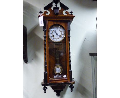 A LATE VICTORIAN VIENNA TYPE WALL CLOCK WITH TWO PART ENAMEL DIAL AND STRIKING MOVEMENT BY JUNGHANS.