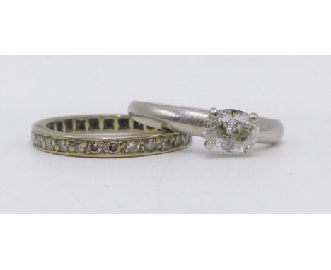 A WHITE METAL DIAMOND SET FULL ETERNITY RING (FINGER SIZE K)  TOGETHER WITH A PLATINUM HALLMARKED OVAL SHAPED DIAMOND RING HO