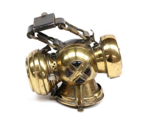 An Early 20th Century Joseph Lucas Microphote Brass Bicycle Lamp, with pivoting mounting bracket, each side set with two gree