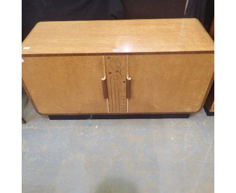 Art Deco period birds eye maple sideboard with carved swirl decoration on central panel, made by Harrison Gibson Ltd of Ilfor