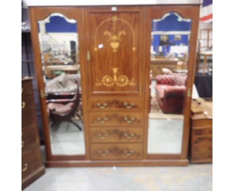 A substantial combination wardrobe, inlaid walnut, comprising two mirrored doors with fitted interiors and a central press ab