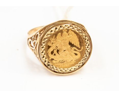 An Elizabeth II 1986 angel, in a 9ct gold ring mount, scroll pierced shank, size U, weight approx. 6.18 grams Condition repor