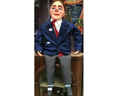 A mid to late 20th Century ventriloquist's puppet of Archie Andrews, papier mache head, wearing a blazer and grey trousersCR;