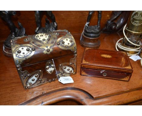 A Victorian Gothic walnut tea caddy, the domed lid and front applied with decorative brass and ivory mounts, the lid opening 