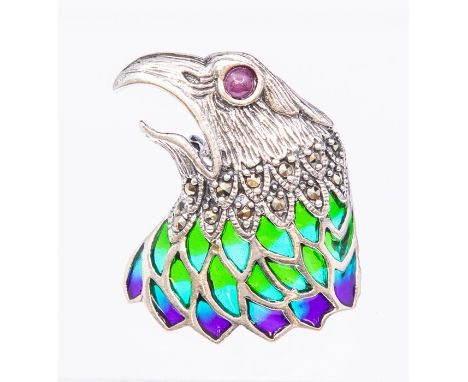 A silver and pliqué a jour enamel brooch/pendant in the form of an eagle, ruby cabochon set eye with marcasite set and green 