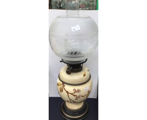 An early 20th Century ceramic and glass oil lamp with funnel and shade oil section (AF) peach tree hand painted design
