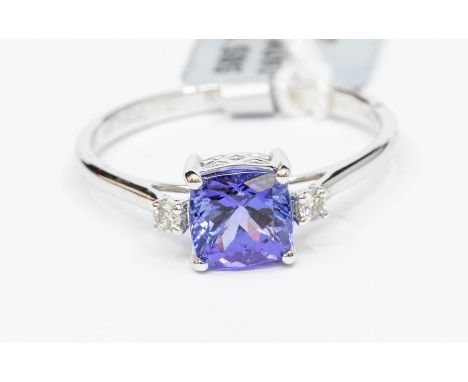 A tanzanite and diamond 14ct white gold ring, comprising a cushion shaped tanzanite, weight approx. 2 carats, with small bril